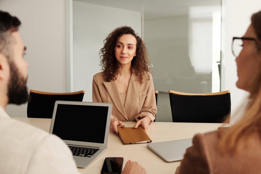 woman-in-a-job-interview-4344878 A woman in a business suit participates in a job interview, showcasing professionalism and modern office environment.